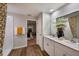 Well-lit bathroom features a double vanity, decorative mirror, and walk-in shower at 1716 Vanilla St, Haines City, FL 33844