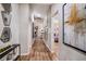 Hallway with wood floors, art pieces, and an open doorway into the living room at 1716 Vanilla St, Haines City, FL 33844
