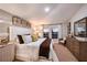 Cozy main bedroom has decorative pillows, side tables, lamps, and art pieces on the wall at 1716 Vanilla St, Haines City, FL 33844