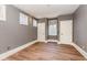 An empty bedroom features neutral gray walls, white trim, and hardwood floors, creating a blank canvas for personalization at 952 Moss Ln, Winter Park, FL 32789