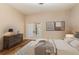 Bright bedroom with sliding glass doors, a plush bed, hardwood floors, and a stylish dresser showcases comfort and elegance at 952 Moss Ln, Winter Park, FL 32789
