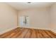 Open bedroom with hardwood floors and glass patio doors provides natural light and a sense of spaciousness and connection to outdoors at 952 Moss Ln, Winter Park, FL 32789