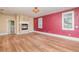 Bedroom with a fireplace and red accent wall at 952 Moss Ln, Winter Park, FL 32789