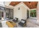 Inviting covered patio with wood ceiling, tile flooring, and comfortable outdoor seating area at 952 Moss Ln, Winter Park, FL 32789