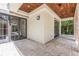 Inviting covered patio with wood ceiling, tile flooring, and comfortable outdoor seating area at 952 Moss Ln, Winter Park, FL 32789