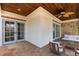 Inviting covered patio with wood ceiling, tile flooring, and comfortable outdoor seating area at 952 Moss Ln, Winter Park, FL 32789