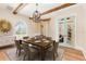 Elegant dining room with wood beams, chandelier, and light blue framed glass doors to complete the space at 952 Moss Ln, Winter Park, FL 32789