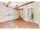 Elegant dining room with wood beams, arched window, and light blue framed glass doors for a cozy yet bright atmosphere at 952 Moss Ln, Winter Park, FL 32789