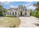 Charming two-story home featuring stucco siding, a tile roof, arched windows, and a brick driveway at 952 Moss Ln, Winter Park, FL 32789