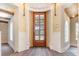 Elegant foyer features a wood-framed glass door, decorative archways, and hardwood floors at 952 Moss Ln, Winter Park, FL 32789