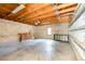 Spacious unfinished garage with exposed wood beams, cinder block walls, and concrete flooring at 952 Moss Ln, Winter Park, FL 32789