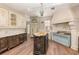 Charming kitchen features custom cabinetry, center island, marble countertops, and a stylish blue oven range at 952 Moss Ln, Winter Park, FL 32789