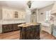 Charming kitchen features custom cabinets, center island, marble countertops, a sink, and ornate detailing at 952 Moss Ln, Winter Park, FL 32789