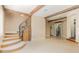 Open-concept living area featuring exposed beams, a staircase with iron railing and stone steps at 952 Moss Ln, Winter Park, FL 32789