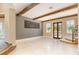 Spacious living area with exposed beams, large windows, and a stone fireplace and wood accents throughout the space at 952 Moss Ln, Winter Park, FL 32789