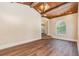 Bright living room with hardwood floors, large windows, a fireplace, and a wood-beamed ceiling at 952 Moss Ln, Winter Park, FL 32789