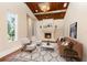 Cozy living room with fireplace, wood-beamed ceiling, and plush seating at 952 Moss Ln, Winter Park, FL 32789