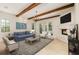 Cozy living room features a fireplace, blue sofa and French doors leading to an outdoor space at 952 Moss Ln, Winter Park, FL 32789