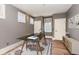 A stylish, gray-walled office features a modern glass desk, windows, and contemporary decor creating an inviting workspace at 952 Moss Ln, Winter Park, FL 32789