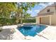 Backyard oasis featuring sparkling pool, raised spa, and lush landscaping at 952 Moss Ln, Winter Park, FL 32789