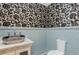 Unique powder room featuring black and white wallpaper and modern vanity at 952 Moss Ln, Winter Park, FL 32789