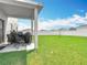 Large backyard with white fence, covered patio and seating area at 1508 Majestic Ln, Winter Haven, FL 33880