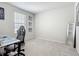 Well-lit bedroom with neutral carpet, a gray gaming chair, and decorative butterfly wall art at 1508 Majestic Ln, Winter Haven, FL 33880