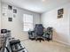 Spare bedroom with gray carpet, a black futon, and a desk and gaming setup by the window at 1508 Majestic Ln, Winter Haven, FL 33880