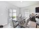 Modern dining area featuring a marble-top table with seating for six and sliding glass doors at 1508 Majestic Ln, Winter Haven, FL 33880