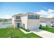 Charming two-story home with blue shutters, landscaped yard, and attached two car garage at 1508 Majestic Ln, Winter Haven, FL 33880