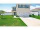Well-maintained front yard with lush green grass leading to a charming two-story home at 1508 Majestic Ln, Winter Haven, FL 33880