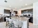 Bright kitchen featuring dark cabinets, granite countertops, stainless appliances, and bar stool seating at 1508 Majestic Ln, Winter Haven, FL 33880