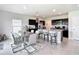 Open-concept kitchen with dark cabinets, granite countertops, an island, and stainless steel appliances at 1508 Majestic Ln, Winter Haven, FL 33880
