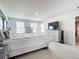 Spacious main bedroom featuring light gray walls, a large bed, and dresser with TV at 1508 Majestic Ln, Winter Haven, FL 33880