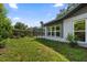 The backyard features a screened-in pool, manicured lawn and landscaping, for outdoor enjoyment and privacy at 19795 Sw 85Th Loop, Dunnellon, FL 34432