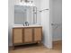 Bathroom featuring a modern vanity with a large mirror and an adjacent walk-in closet at 19795 Sw 85Th Loop, Dunnellon, FL 34432