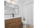 Modern bathroom with a sleek vanity, a large mirror, and a window offering natural light at 19795 Sw 85Th Loop, Dunnellon, FL 34432
