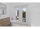 Bathroom featuring a modern vanity and French doors that lead to the home's exterior at 19795 Sw 85Th Loop, Dunnellon, FL 34432