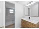 Modern bathroom with stylish vanity, rectangular mirror and a walk-in shower with gray tile at 19795 Sw 85Th Loop, Dunnellon, FL 34432