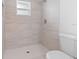 Modern walk-in shower with gray tile and updated fixtures next to the toilet at 19795 Sw 85Th Loop, Dunnellon, FL 34432