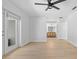 Bedroom featuring light wood floors, ceiling fan, and access to the bathroom at 19795 Sw 85Th Loop, Dunnellon, FL 34432