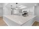 Open kitchen featuring stainless steel appliances, quartz countertops, and bright lighting at 19795 Sw 85Th Loop, Dunnellon, FL 34432