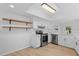 Updated kitchen with stainless steel appliances, white cabinets, and open shelving at 19795 Sw 85Th Loop, Dunnellon, FL 34432