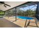 Inviting screened-in pool area features a sparkling pool and ample space for outdoor relaxation and entertaining at 19795 Sw 85Th Loop, Dunnellon, FL 34432
