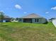 Expansive backyard features green lawn and rear home elevation in a bright, sunny setting at 3148 Caspian Feather St, Bartow, FL 33830