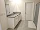 Bathroom featuring a double vanity with granite countertop and tiled flooring at 3148 Caspian Feather St, Bartow, FL 33830