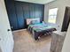 Nicely decorated bedroom featuring a themed accent wall, carpeted floor, and natural light at 3148 Caspian Feather St, Bartow, FL 33830