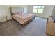 Bedroom with neutral carpet, large window, and a comfortable bed with soft-toned bedding at 3148 Caspian Feather St, Bartow, FL 33830