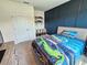 Stylish bedroom with custom accent wall, natural light, and carpeted flooring at 3148 Caspian Feather St, Bartow, FL 33830