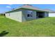 Exterior rear view showcasing a covered patio, and ample backyard space at 3148 Caspian Feather St, Bartow, FL 33830